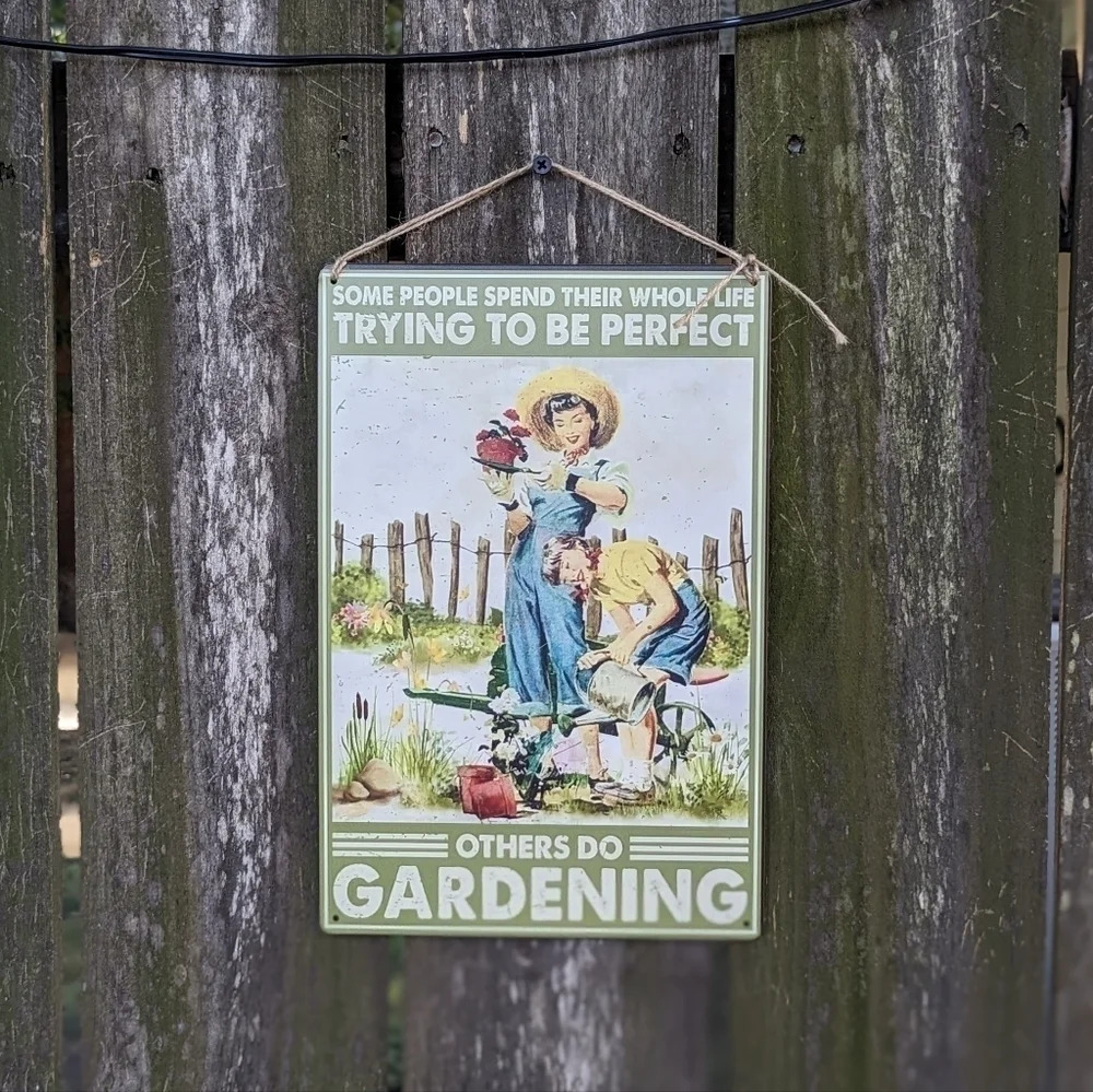 "people spend their whole life trying to be perfect" tin metal gardening sign